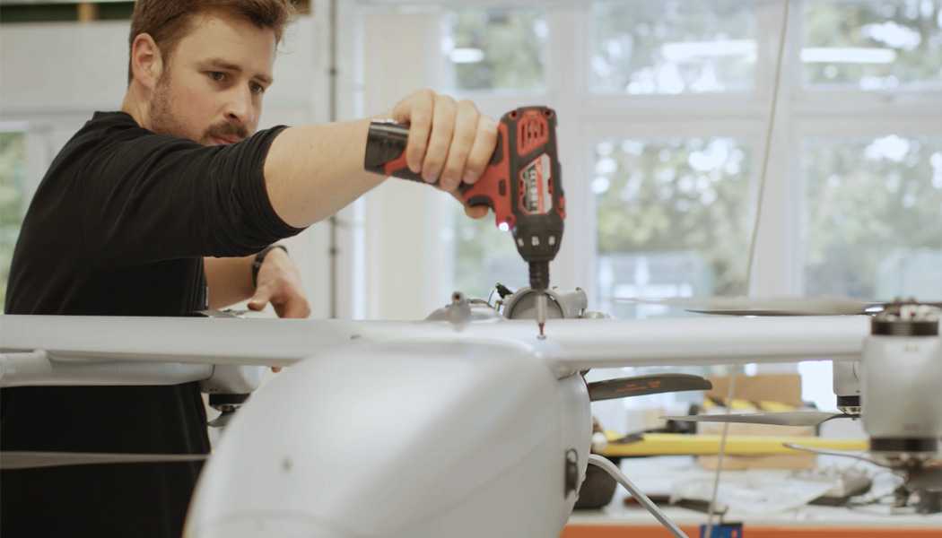 An engineer assembling a drone